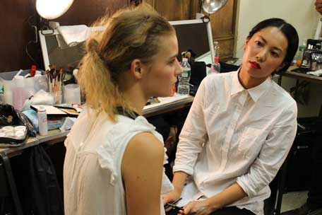 mac-makeup-artist-examining-her-work-at-jen-kao-ss13